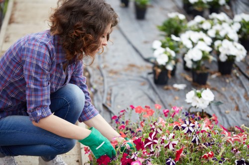 Gardener assessing a garden with tools and safety gear