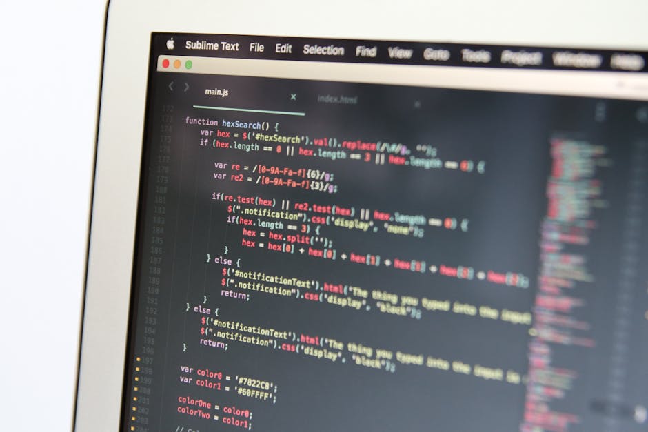 A close-up of a computer screen displaying a code editor with lines of JavaScript code, featuring functions related to hex color search and notification management. The screen shows a dark-themed inte
